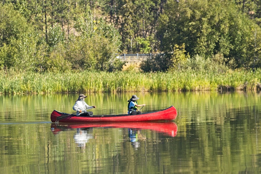 two men in a canoe on the lake participating in experiential therapy for addiction