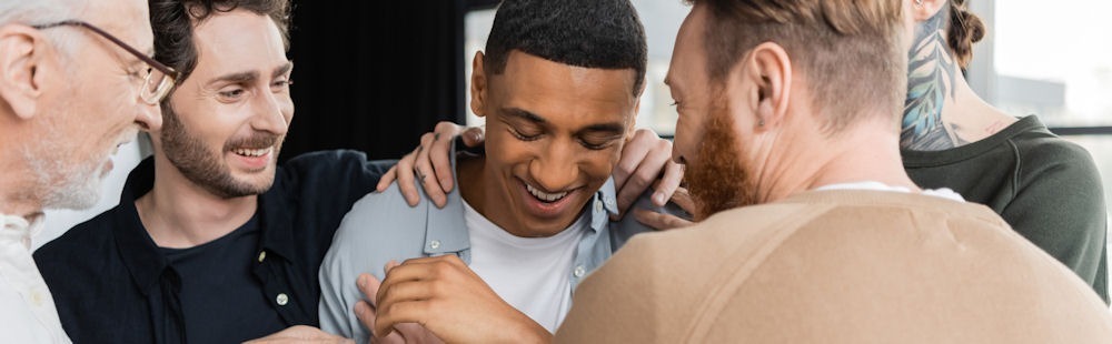 group of men hugging man in meeting