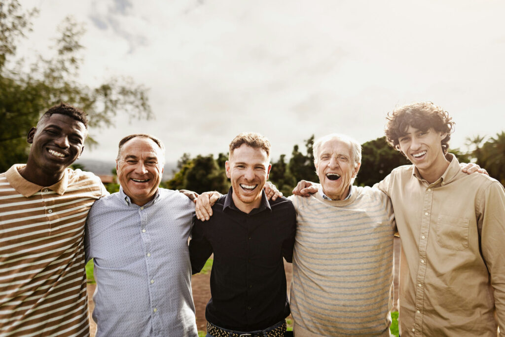Group of men in recovery standing together outdoors in Colorado near sober living home