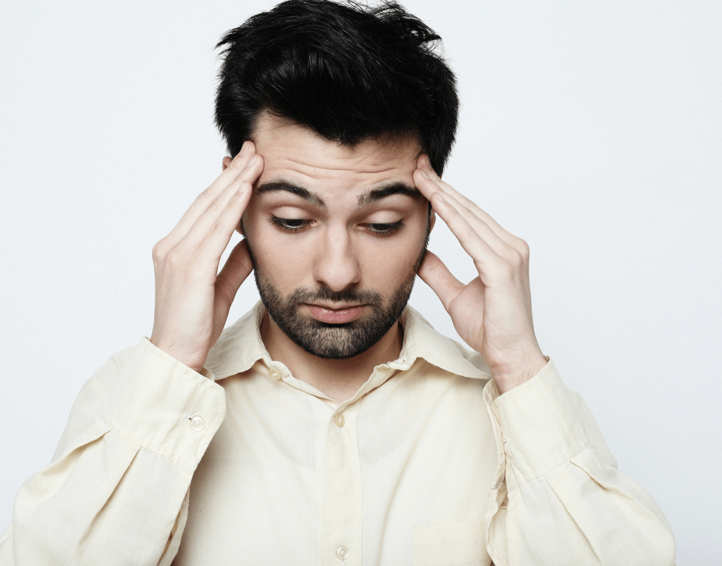 Adult experiencing dizziness and drowsiness, common side effects of mixing gabapentin and alcohol.